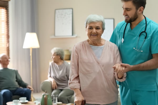 nurse helping elder woman